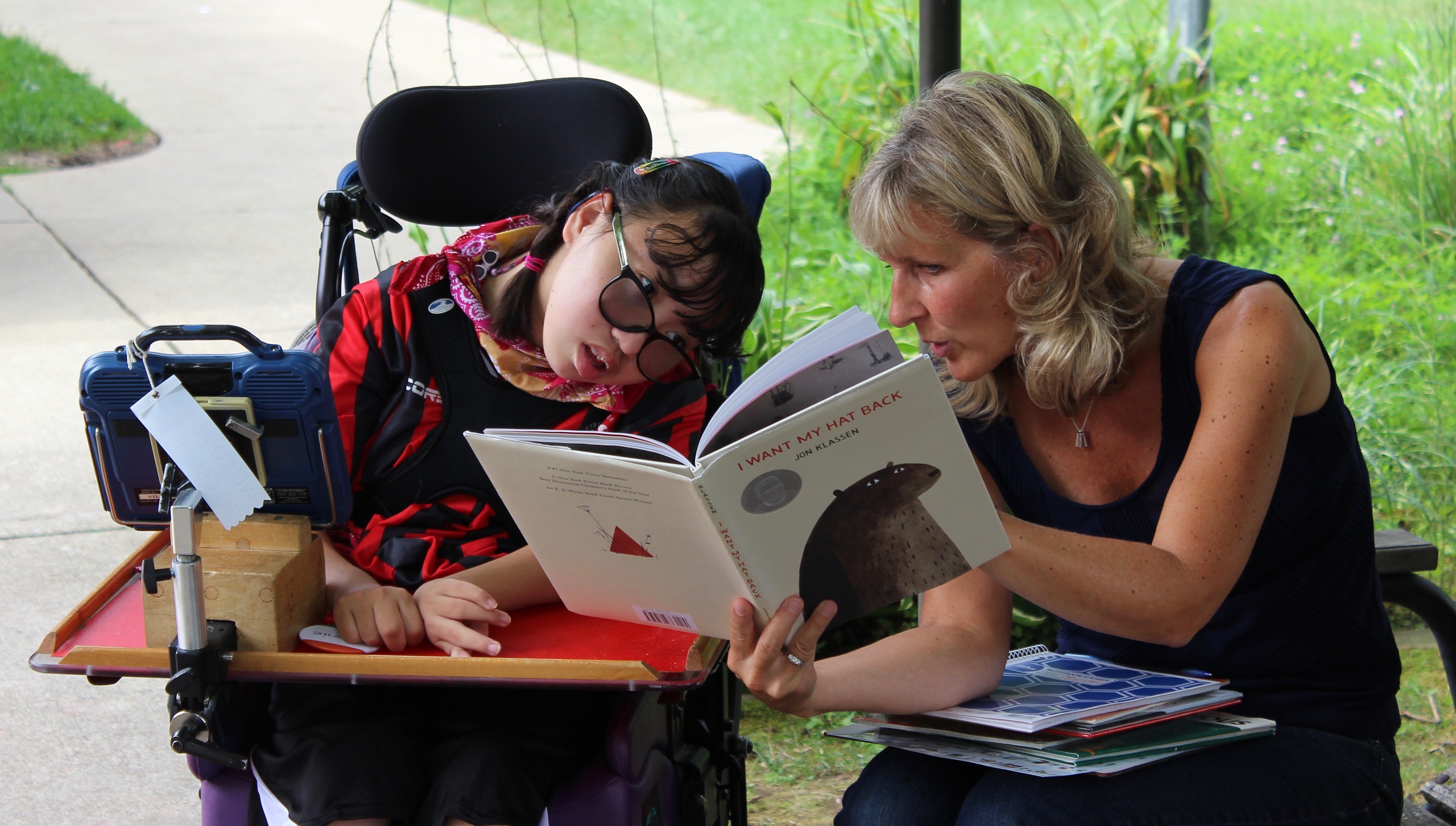 an adult reads to a child with disabilities